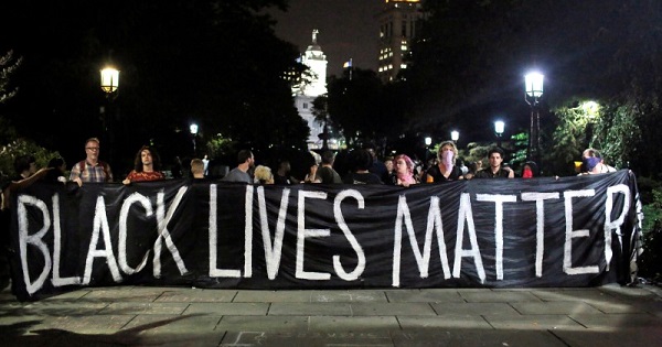 People hold up a banner during a Black Lives Matter protest outside City Hall in Manhattan, New York, U.S., on August 1, 2016.