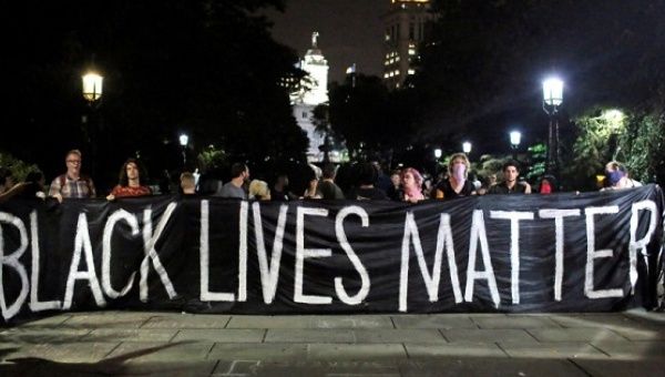 People hold up a banner during a Black Lives Matter protest outside City Hall in Manhattan, New York, U.S., on August 1, 2016.