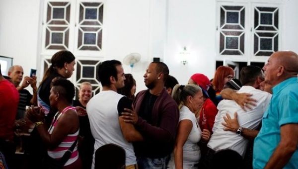 People embrace each other during a mass in a church in Matanzas, Cuba, May 5, 2017. 