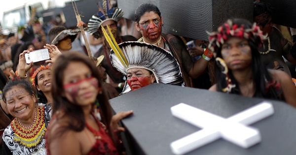 Indigenous people carry mock coffins during a demonstration against the violation of Indigenous people's rights, in Brasilia, April 25, 2017.