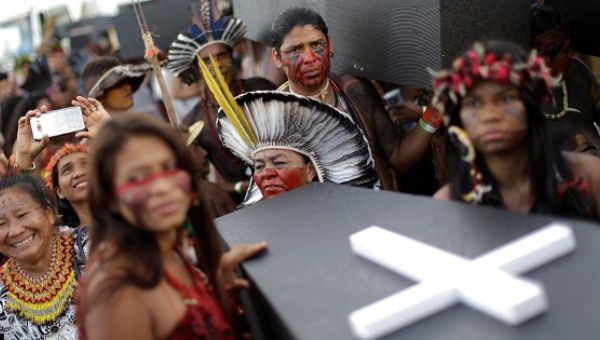 Indigenous people carry mock coffins during a demonstration against the violation of Indigenous people's rights, in Brasilia, April 25, 2017.