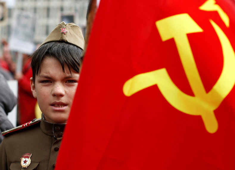 A boy is pictured beside a Soviet flag during celebrations to mark Victory Day in Berlin, Germany May 9, 2017. 