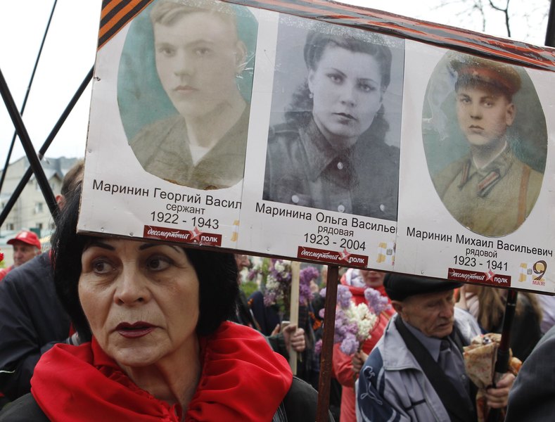 A woman holds pictures of World War Two soldiers as she take part in the Immortal Regiment march during the Victory Day celebrations, marking the 72nd anniversary of the victory over Nazi Germany in World War Two, in the southern city of Stavropol, Russia, May 9, 2017. 