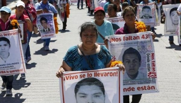 Relatives of the 43 missing students of the Ayotzinapa teacher training college march before receiving the final report on the disappearance of their sons by members of the Inter-American Commission on Human Rights (IACHR) in Tixtla, Guerrero state, Mexico, April 27, 2016.