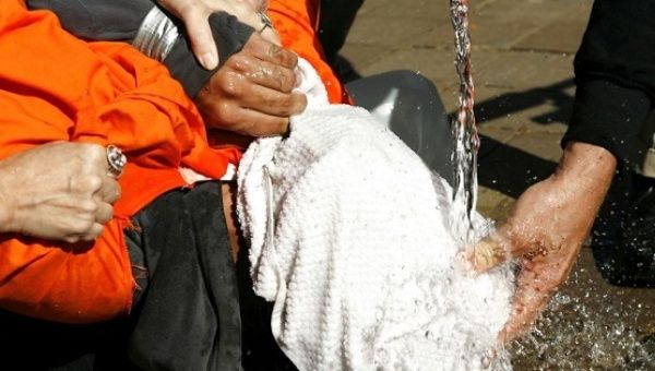 A demonstrator is held down during a simulation of waterboarding outside the Justice Department in Washington November 5, 2007. 