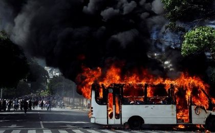 A group of hooded men in Caracas took a public bus driver hostage on Saturday and then set his vehicle on fire.