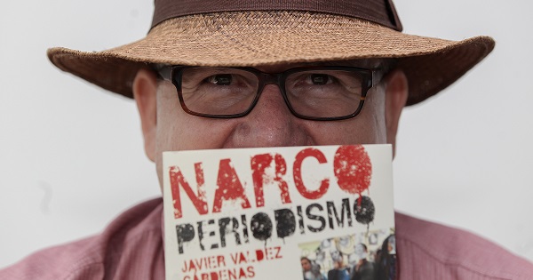 Javier Valdez poses with his book 