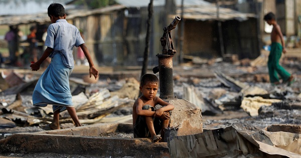 A boy sits in a burnt area after fire destroyed shelters at a camp for internally displaced Rohingya Muslims in Rakhine State, Myanmar, on May 3, 2016.