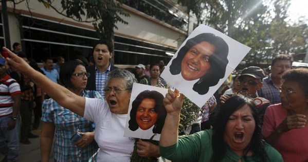 Activists hold photos of slain Honduran environmental activist Berta Caceres.