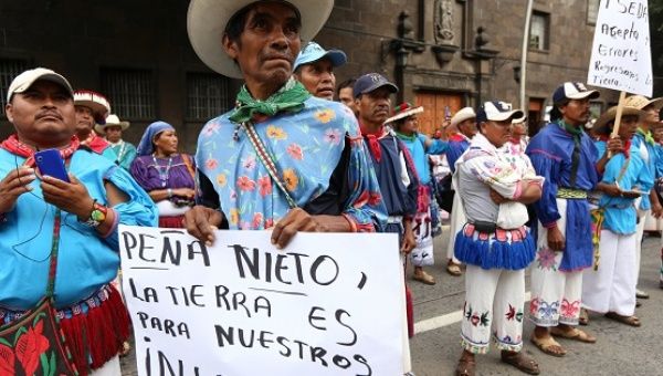 Indigenous Wixarika people march for land rights in the Mexican city of Guadalajara, Aug. 20, 2014.