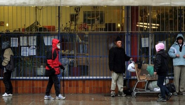 Homeless residents of the Downtown Eastside, in Vancouver, British Colombia, seek shelter from the rain.