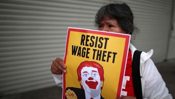 Fast food workers and supporters protest outside of a McDonald's restaurant in Los Angeles, California, on May 24, 2017.