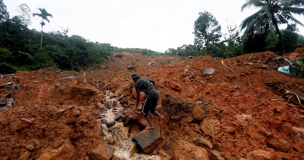 A military official walks through the mud at the site of a landslide in Bellana village in Kalutara, Sri Lanka, on May 26, 2017.
