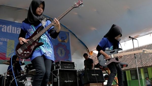 Widi Rahmawati (L) and Firdda Kurnia, members of the metal Hijab band Voice of Baceprot, perform during a school's farewell event in Garut, Indonesia, May 15, 2017. 