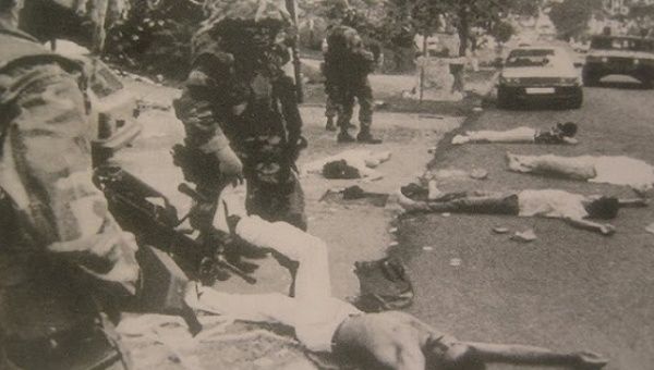U.S. troops guarding over Panamanian civilians who were killed in the invasion.