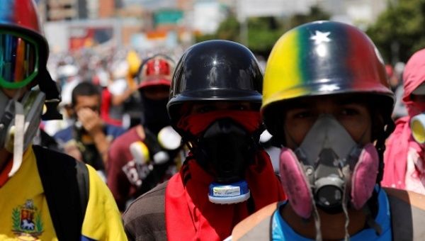 Right-wing demonstrators wearing gas masks take part in a protests in Caracas, Venezuela, May 29, 2017. 