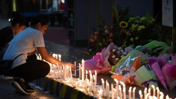 Employees light candles during a memorial at Resorts World in Pasay City, Metro Manila, Philippines June 2, 2017. 
