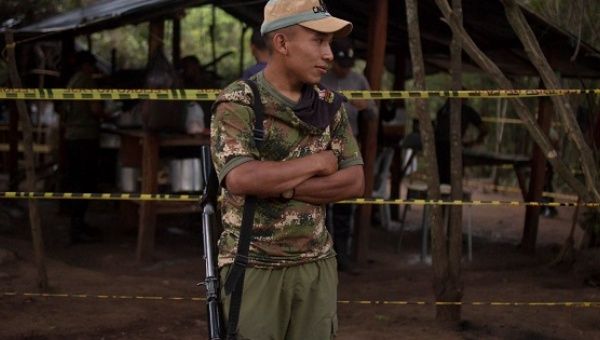 A member of the FARC waits in a demobilization zone, Dec 5, 2016.