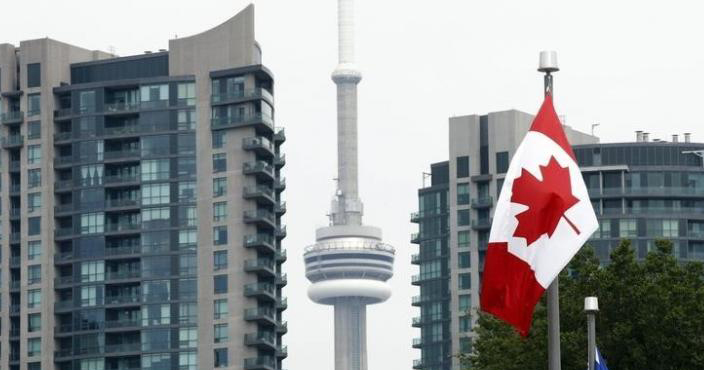 A general of a Canadian flag on Princes' Boulevard with the CN Tower in the background. (File)