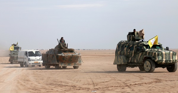 Syrian Democratic Forces (SDF) fighters ride on vehicles in the north of Raqqa city, Syria February 5, 2017