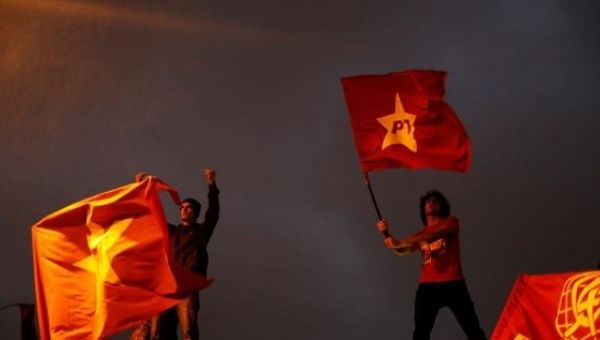 Protesters wave the Workers Party flag in a protest against unelected President Michel Temer.