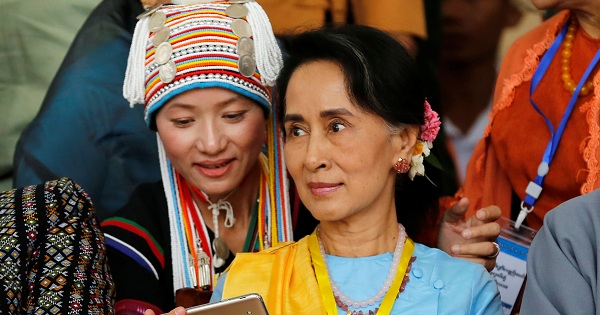 An ethnic woman takes a selfie with Myanmar State Counsellor Aung San Suu Kyi in Naypyitaw, Myanmar, on May 24, 2017.