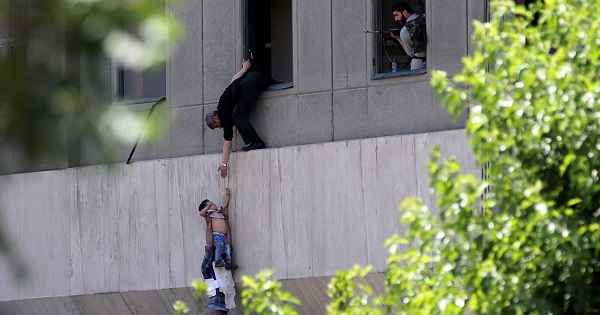 A boy is evacuated during an attack on the Iranian parliament in central Tehran, Iran, on June 7, 2017.