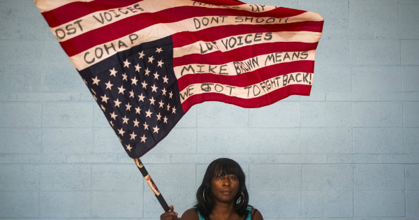 Black woman holding the U.S. flag