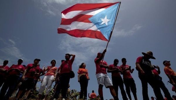 A protester waves a Puerto Rican independence flag during a protest in San Juan.