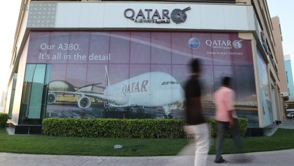People walk past the Qatar Airways office in Manama, Bahrain, on June 8, 2017. 