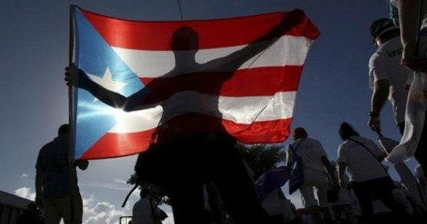 A protester holding a Puerto Rican flag.