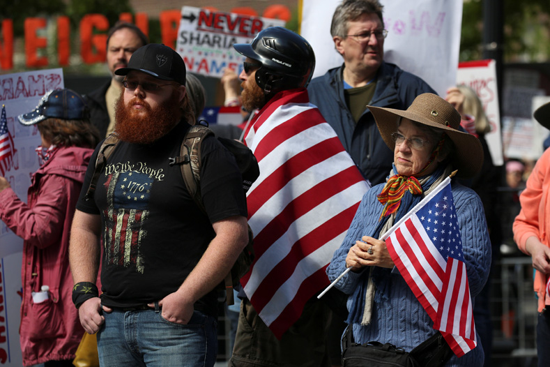 Attendees listen during an anti-Sharia rally in Seattle, Washington, U.S., June 10, 2017. 