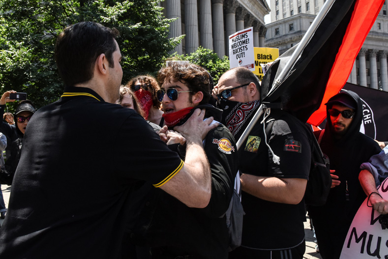 A participant confronts a group of counter protesters during an event called 