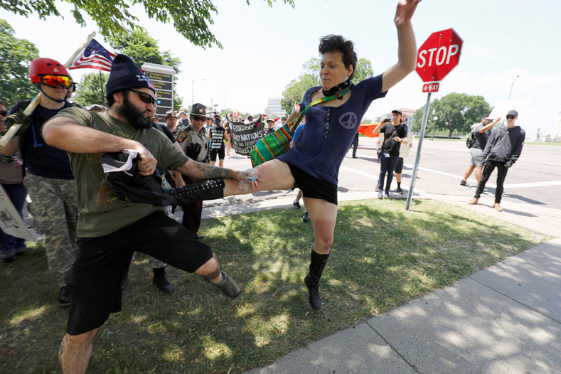 Anti-Muslim protesters scuffle with counter demonstrators and members of the Minnesota State Patrol at the state capitol in St. Paul, Minnesota, U.S. June 10, 2017.