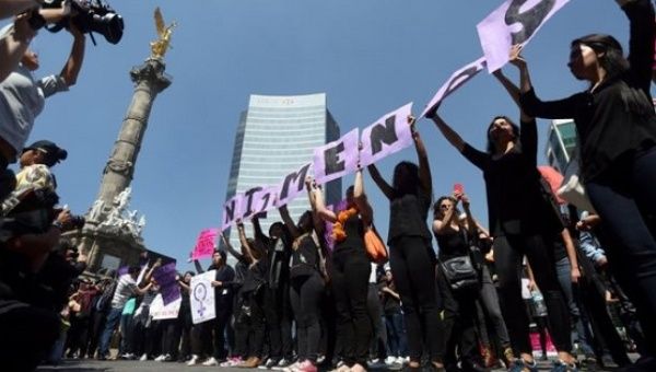 Women participate in a protest against femicide in Mexico City.