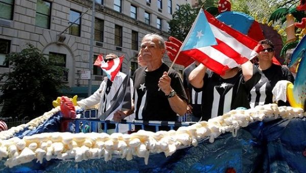 Oscar Lopez Rivera on gets a place of honor on first float in the New York Puerto Rican Day Parade.