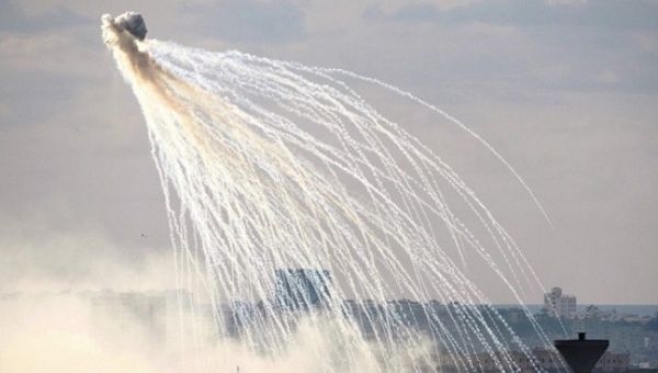 Photo showing white phosphorous, with its characteristic white trailed showers. 