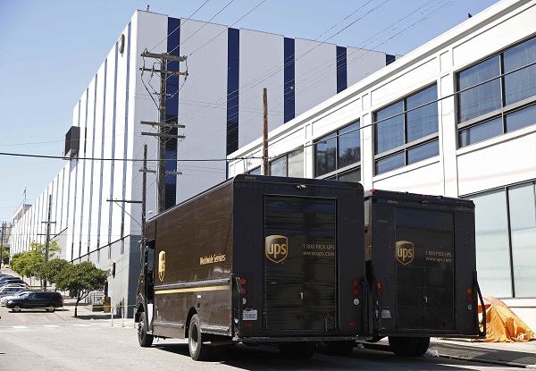 United Parcel Service vans parked outside the company's packing facility where a shooting incident took place