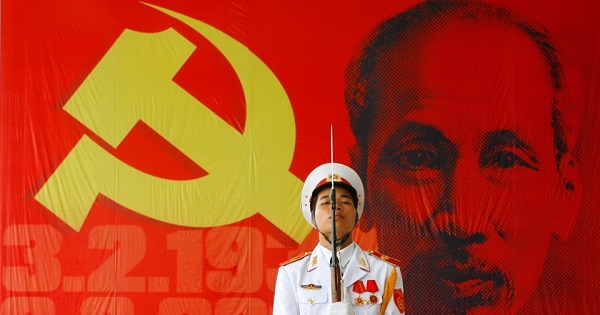 A soldier holds a rifle in front of a giant image of Vietnam's late revolutionary leader Ho Chi Minh, outside a ceremony to celebrate his birthday in Hanoi.