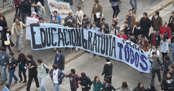 Chilean students carry a banner that says 