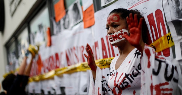 An activist protests against the murder of journalists in Mexico, outside the building of Attention to Crimes against Freedom of Expression in Mexico City.