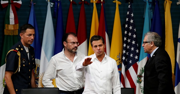 Mexico's President Pena Nieto next to OAS Secretary General Almagro and Mexico's Foreign Minister Videgaray at the OAS General Assembly in Cancun