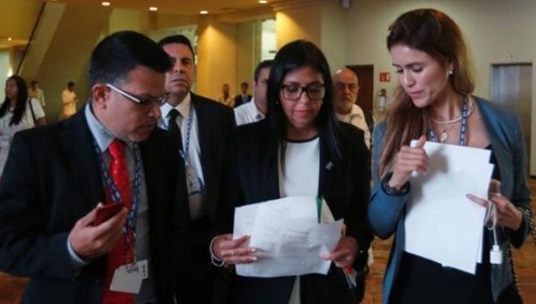 Venezuelan Foreign Minister Delcy Rodriguez (C) check some documents with the delegation after a meeting with foreign ministers ahead of the OAS 47th General Assembly in Cancun, Mexico, June 19, 2017.