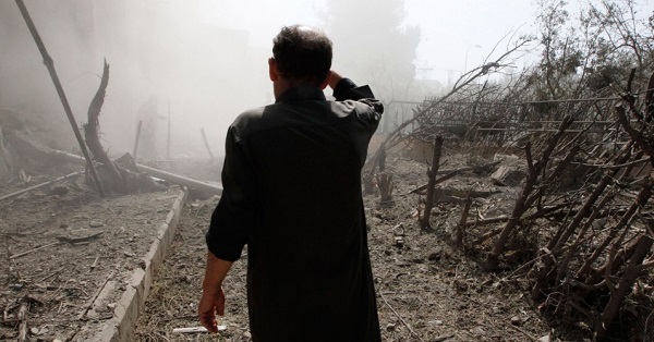 A man walks through rubble in Eastern Syria.