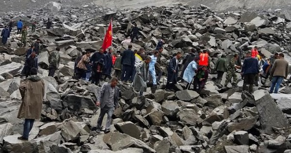 Rescuers search for survivors following a landslide in China that left 141 missing.