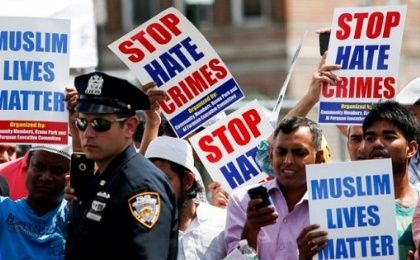 Community members take part in a protest to demand stop hate crime in Queens, New York. 