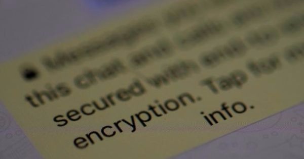 An encryption message is seen on the WhatsApp application on an iPhone in Manchester , Britain March 27, 2017.