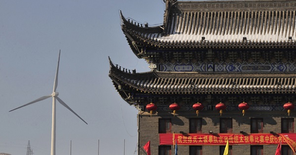 A wind turbine is seen near a gate of the ancient city of Wushu in Diaobingshan.