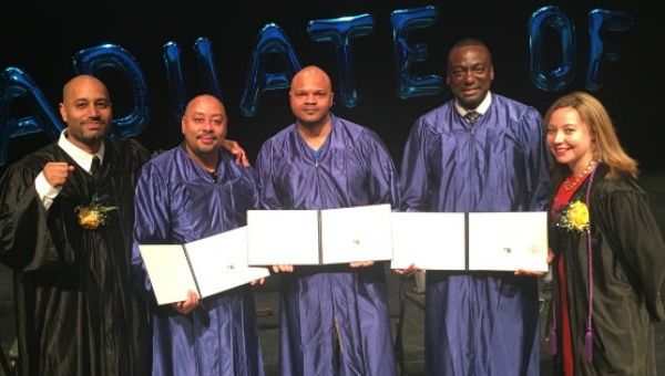 The men, now in their 40s, were clad in blue graduation gowns at Monday's ceremony.