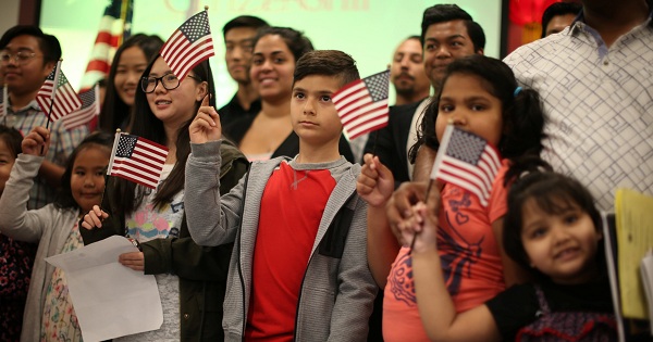 Children say the pledge of allegiance during a ceremony to present citizenship certificates in Los Angeles, California, U.S., on May 31, 2017.